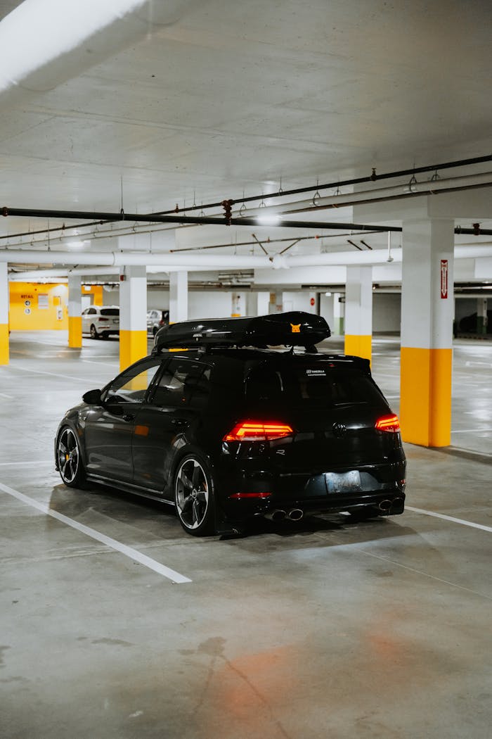 Black car parked in urban parking garage